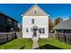 Charming two-story home with light gray siding, a welcoming front porch, and green lawn at 2251 N New Jersey St, Indianapolis, IN 46205