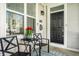 Inviting front porch with cozy seating and decorative tulips, perfect for enjoying the outdoors at 2251 N New Jersey St, Indianapolis, IN 46205
