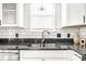 Close up of kitchen sink features sleek faucet and dark countertops at 2251 N New Jersey St, Indianapolis, IN 46205