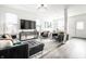 Stylish living room with leather seating, modern decor, and plenty of natural light at 2251 N New Jersey St, Indianapolis, IN 46205