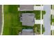 Aerial view of a home near a pond featuring a playground and covered patio enhancing the property's appeal at 2396 Creek Bank Dr, Columbus, IN 47201