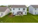 Aerial view of the backyard with a covered patio, swing set, and lush green lawn at 2396 Creek Bank Dr, Columbus, IN 47201