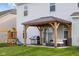 Backyard featuring a covered patio with outdoor seating and a grill, adjacent to a swing set for Gathering fun at 2396 Creek Bank Dr, Columbus, IN 47201