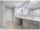 Bright bathroom with double vanity, gray cabinets, tile floors, and a separate shower at 2396 Creek Bank Dr, Columbus, IN 47201