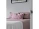 Cozy bedroom showcasing a bed dressed in pink quilt and soft pink decorative pillows at 2396 Creek Bank Dr, Columbus, IN 47201