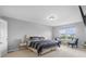 Serene bedroom features a queen bed, window, and sitting area with two chairs for relaxation at 2396 Creek Bank Dr, Columbus, IN 47201