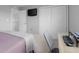 Clean bedroom showcasing a closet, a bed dressed in pink quilt and a workspace at 2396 Creek Bank Dr, Columbus, IN 47201