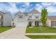 Charming two-story home with a well-manicured lawn and inviting front porch at 2396 Creek Bank Dr, Columbus, IN 47201
