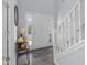Bright foyer featuring wood floors, stairs, and a console table with decor at 2396 Creek Bank Dr, Columbus, IN 47201