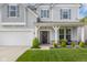 Charming home featuring a welcoming front porch, a two-car garage, and a lovely lawn at 2396 Creek Bank Dr, Columbus, IN 47201
