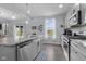 Open kitchen features stainless appliances, granite countertops, and hardwood floors at 2396 Creek Bank Dr, Columbus, IN 47201