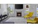 Bright living room with a fireplace, complemented by stylish seating and a large window view at 2396 Creek Bank Dr, Columbus, IN 47201