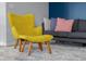 Comfortable living room featuring a yellow chair, neutral rug, and gray sofa with accent pillows at 2396 Creek Bank Dr, Columbus, IN 47201