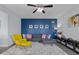 Cozy living area featuring a gray sofa, a stylish yellow chair, and a decorative blue accent wall at 2396 Creek Bank Dr, Columbus, IN 47201