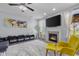 Open-concept living room with fireplace, media center, comfortable seating, and scenic backyard views at 2396 Creek Bank Dr, Columbus, IN 47201
