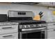 Close up of an oven next to gray cabinets and granite countertops at 2396 Creek Bank Dr, Columbus, IN 47201