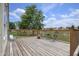 Spacious wooden back deck with serene views of the green backyard and a tranquil pond at 2449 Orchard Creek Dr, Columbus, IN 47201