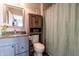 Bathroom with vanity, granite countertop, wooden shelving, toilet, and shower at 2449 Orchard Creek Dr, Columbus, IN 47201
