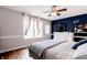This bedroom features a ceiling fan, a window with curtains, and a door to the outside at 2449 Orchard Creek Dr, Columbus, IN 47201