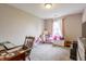 Bedroom with natural light, neutral walls, carpet flooring, and decorated with toys at 2449 Orchard Creek Dr, Columbus, IN 47201