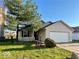 Charming two-story home with attached garage, front porch, and a well-manicured lawn at 2449 Orchard Creek Dr, Columbus, IN 47201