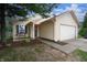Charming home with an attached garage, complemented by mature trees and a well-kept lawn at 2449 Orchard Creek Dr, Columbus, IN 47201