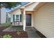 Inviting home exterior with a black front door, wreath, bench and well-maintained landscaping at 2449 Orchard Creek Dr, Columbus, IN 47201