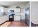 Bright kitchen with white cabinets, granite countertops, stainless steel appliances and wood flooring at 2449 Orchard Creek Dr, Columbus, IN 47201