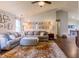 Bright living room featuring a comfortable sectional sofa, a decorative rug, and a gallery wall of Gathering photos at 2449 Orchard Creek Dr, Columbus, IN 47201