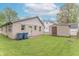 Backyard featuring a small outbuilding and trash receptacles, set against a backdrop of lush green grass at 2539 S Lyons Ave, Indianapolis, IN 46241