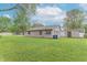 Spacious backyard with lush green grass, mature trees, and a well-maintained lawn, ideal for outdoor activities at 2539 S Lyons Ave, Indianapolis, IN 46241