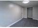 Neutral bedroom features plush carpeting, white trim, and a closet perfect for storage at 2539 S Lyons Ave, Indianapolis, IN 46241