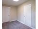 Bedroom featuring neutral walls, carpet flooring, and two doors at 2539 S Lyons Ave, Indianapolis, IN 46241