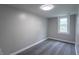 Bedroom features neutral walls, carpet flooring, a window, and bright lighting at 2539 S Lyons Ave, Indianapolis, IN 46241