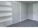 Bedroom view with built-in shelving, gray walls, and neutral carpeting at 2539 S Lyons Ave, Indianapolis, IN 46241