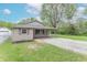Charming one-story home featuring a cozy front porch, stone accents, and a well-maintained lawn at 2539 S Lyons Ave, Indianapolis, IN 46241