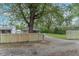 Property featuring a newly constructed wooden fence, a spacious yard, and mature trees surrounding the home at 2539 S Lyons Ave, Indianapolis, IN 46241