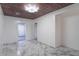 Hallway boasting marble-style tile flooring, a decorative ceiling light fixture, and wood paneling at 2539 S Lyons Ave, Indianapolis, IN 46241