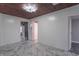Hallway boasting marble-style tile flooring, a decorative ceiling light fixture, and wood paneling at 2539 S Lyons Ave, Indianapolis, IN 46241