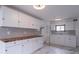 Bright kitchen featuring white cabinets, light gray subway tile backsplash, and gorgeous butcher block countertops at 2539 S Lyons Ave, Indianapolis, IN 46241