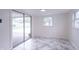 Bright room with sliding glass door, window and marble-style tiled floors at 2539 S Lyons Ave, Indianapolis, IN 46241