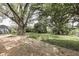 A spacious backyard featuring mature trees and a shed, offering a serene outdoor space at 2706 Shakespeare Dr, Indianapolis, IN 46227