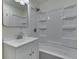 Bright bathroom with a white vanity, sink, and shower-tub combination at 2706 Shakespeare Dr, Indianapolis, IN 46227