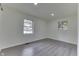 Empty bedroom with two windows and grey wood-look vinyl flooring at 2706 Shakespeare Dr, Indianapolis, IN 46227