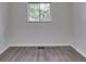 A standard small bedroom with one window and new vinyl flooring at 2706 Shakespeare Dr, Indianapolis, IN 46227