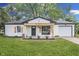 Charming single-story home featuring a freshly painted exterior, front porch, and attached garage at 2706 Shakespeare Dr, Indianapolis, IN 46227