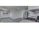Open concept kitchen with stainless steel appliances, white cabinets, and grey vinyl flooring at 2706 Shakespeare Dr, Indianapolis, IN 46227