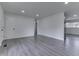 Spacious, light-filled room with gray flooring, white walls, and multiple access points at 2706 Shakespeare Dr, Indianapolis, IN 46227