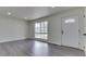 Bright living room featuring a large window and fresh paint, and modern gray flooring at 2706 Shakespeare Dr, Indianapolis, IN 46227