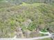 Aerial view of home nestled among lush trees and landscaping with other buildings nearby at 2985 Little Hurricane Rd, Martinsville, IN 46151